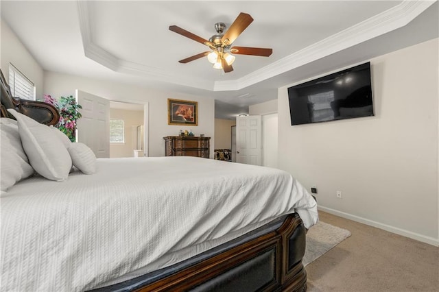 bedroom featuring a tray ceiling, ornamental molding, ceiling fan, and carpet flooring