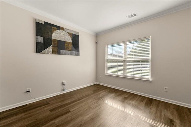 spare room featuring crown molding and hardwood / wood-style floors