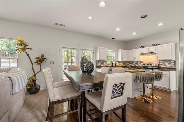 dining area with dark wood-type flooring and sink