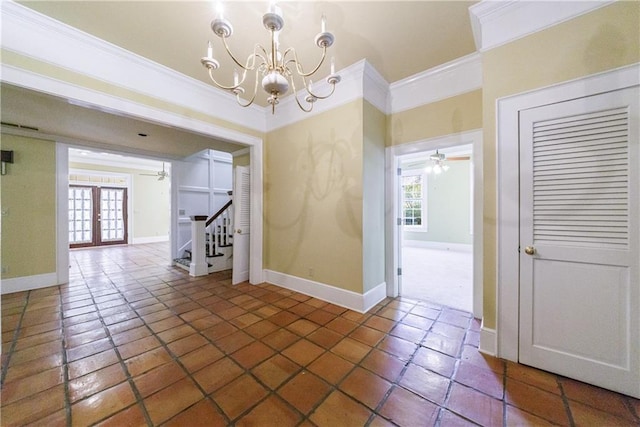 tiled spare room featuring a chandelier, french doors, and ornamental molding