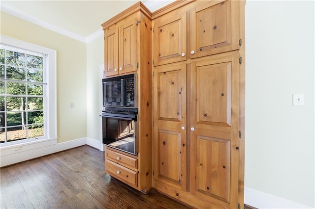 kitchen with dark hardwood / wood-style flooring, plenty of natural light, ornamental molding, and black appliances