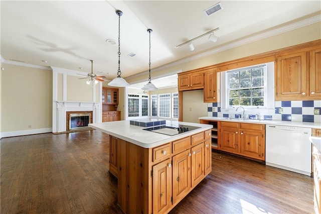 kitchen featuring dishwasher, backsplash, pendant lighting, a kitchen island, and electric stovetop