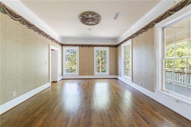 empty room with crown molding and dark wood-type flooring