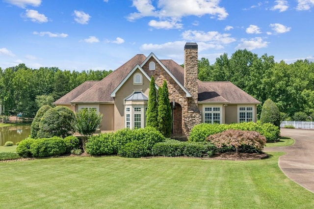 317 Red Gate Overlook, Canton, GA 30115 - view of front facade with a front yard, a chimney, stucco siding, and stone siding