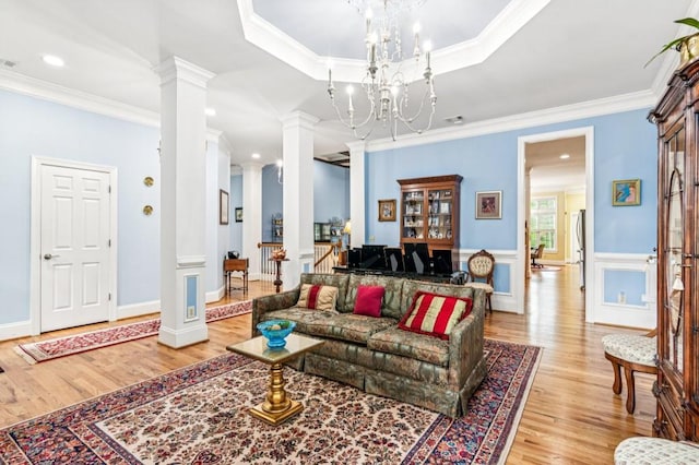 317 Red Gate Overlook, Canton, GA 30115 - living room featuring ornate columns, light wood-style flooring, crown molding, a chandelier, and recessed lighting