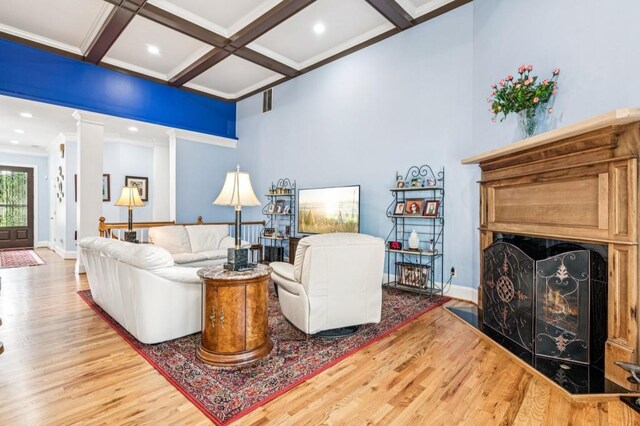 317 Red Gate Overlook, Canton, GA 30115 - living room with wood finished floors, a fireplace with flush hearth, beam ceiling, coffered ceiling, and ornate columns