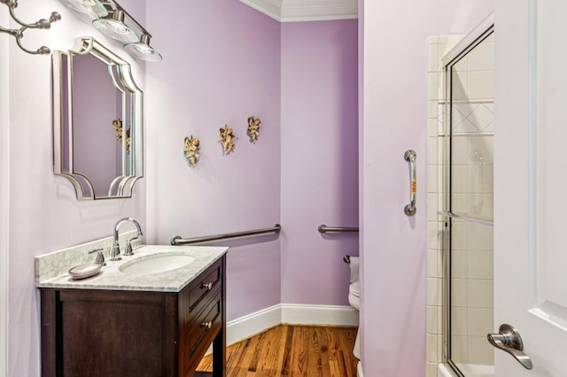 317 Red Gate Overlook, Canton, GA 30115 - full bathroom with vanity, wood finished floors, crown molding, and bath / shower combo with glass door