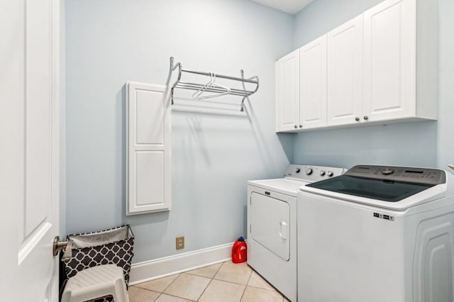 317 Red Gate Overlook, Canton, GA 30115 - laundry area featuring cabinet space, washing machine and clothes dryer, and light tile patterned floors
