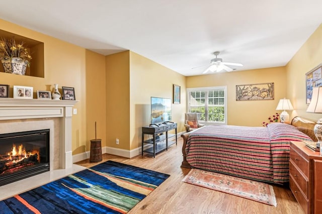 317 Red Gate Overlook, Canton, GA 30115 - bedroom with wood finished floors, a fireplace with flush hearth, and ceiling fan