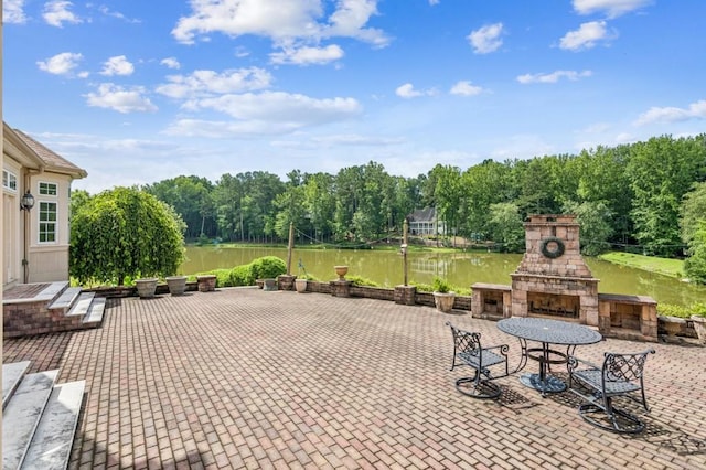 317 Red Gate Overlook, Canton, GA 30115 - view of patio with an outdoor stone fireplace and a water view