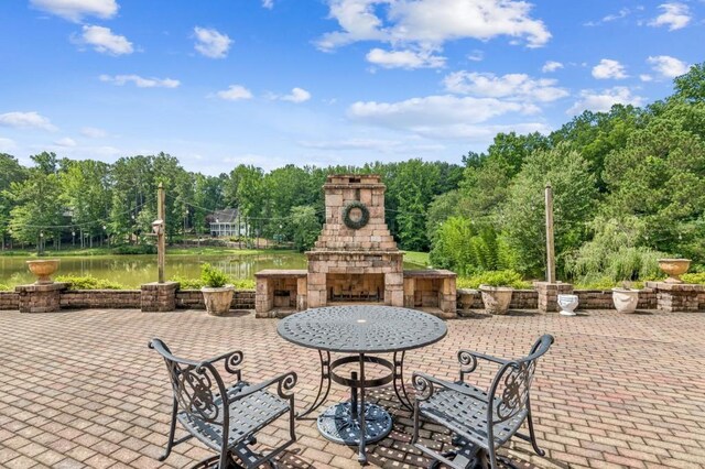 317 Red Gate Overlook, Canton, GA 30115 - view of patio / terrace featuring an outdoor stone fireplace and a water view