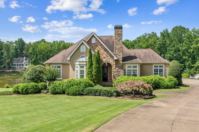 317 Red Gate Overlook, Canton, GA 30115 - view of front facade featuring stucco siding, a front lawn, stone siding, and a chimney