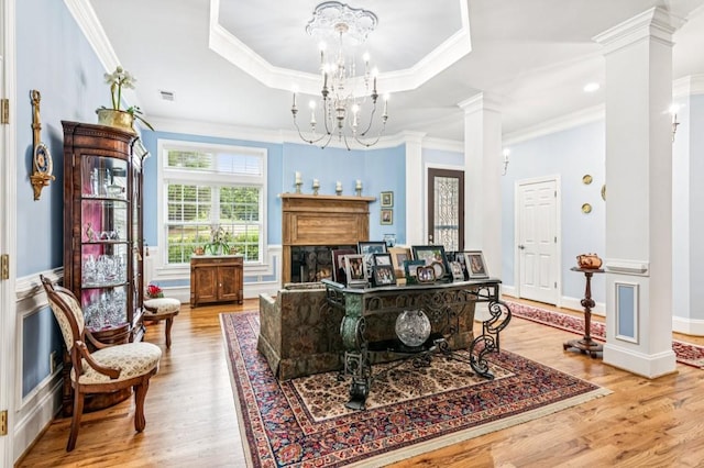 317 Red Gate Overlook, Canton, GA 30115 - living room with decorative columns, ornamental molding, wood finished floors, a chandelier, and a raised ceiling