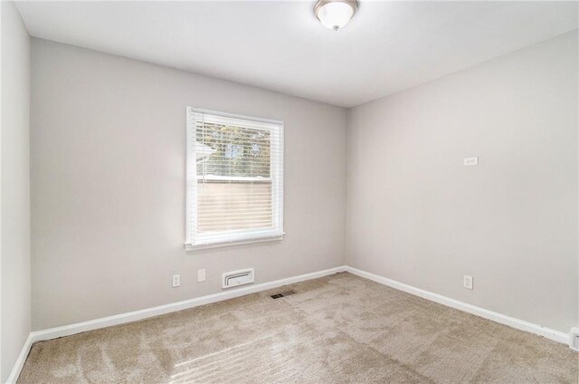 unfurnished room with light colored carpet