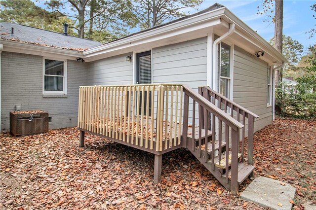 wooden deck featuring central AC unit