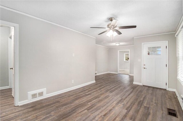 foyer featuring ornamental molding, dark wood-type flooring, and ceiling fan