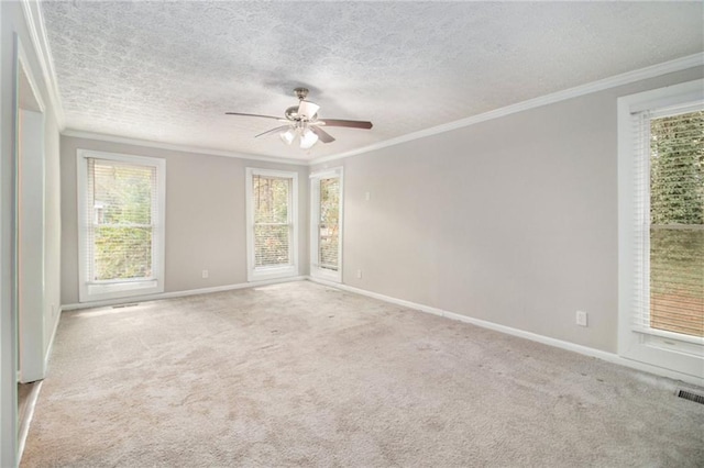 carpeted empty room with ceiling fan, a textured ceiling, and ornamental molding