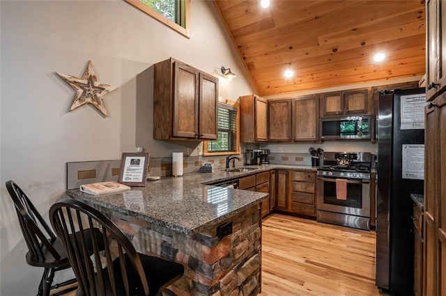 68 Whispering Hawk Ct, Morganton, GA 30560 - kitchen featuring appliances with stainless steel finishes, a peninsula, wooden ceiling, light wood-style floors, and dark stone counters