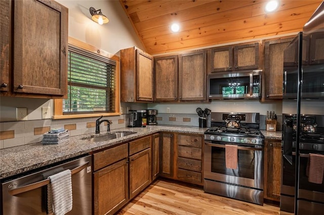 68 Whispering Hawk Ct, Morganton, GA 30560 - kitchen featuring appliances with stainless steel finishes, dark stone countertops, light wood-type flooring, vaulted ceiling, and wooden ceiling