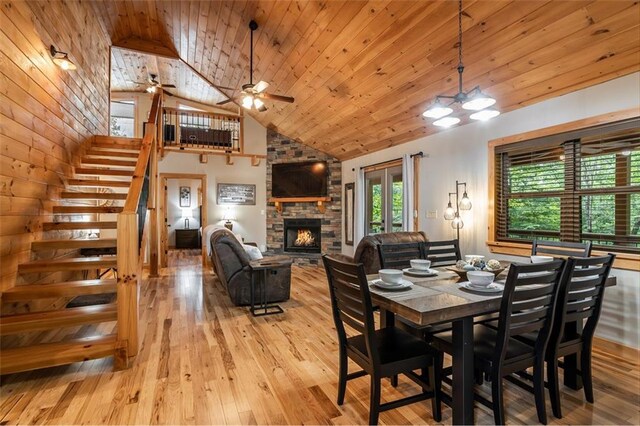 68 Whispering Hawk Ct, Morganton, GA 30560 - dining area featuring stairs, a stone fireplace, hardwood / wood-style floors, high vaulted ceiling, and ceiling fan