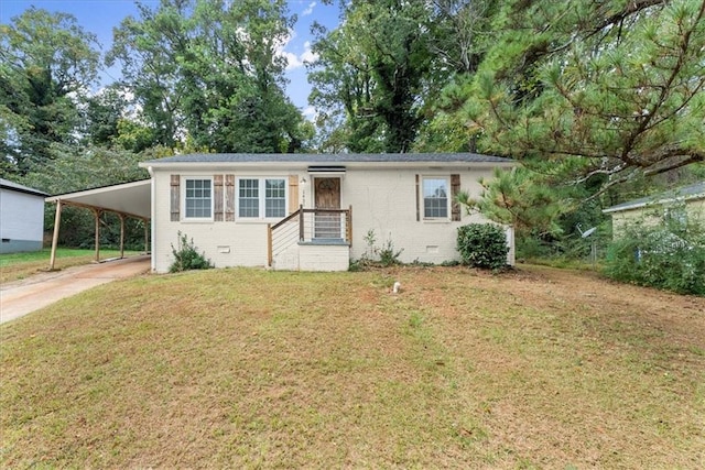 view of front facade with a carport and a front yard