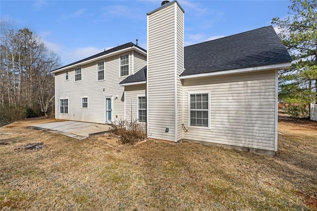 rear view of property with a yard and a patio