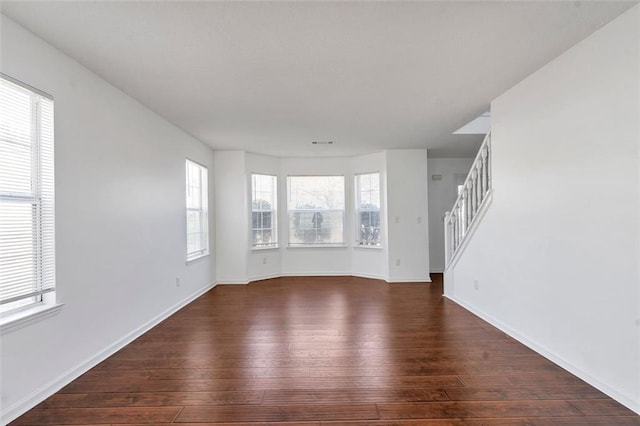 unfurnished living room featuring dark hardwood / wood-style flooring