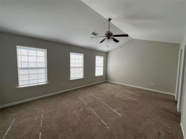 unfurnished room with carpet floors, visible vents, vaulted ceiling, and baseboards