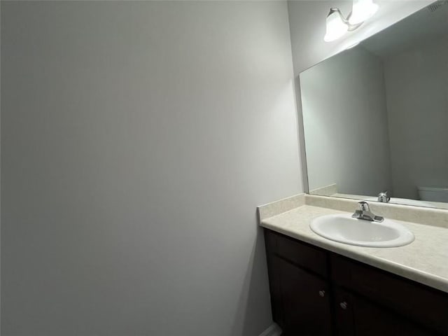 half bathroom with toilet and vanity