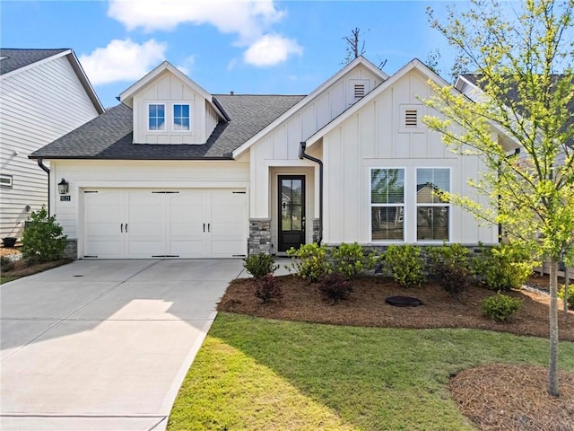 modern farmhouse style home with board and batten siding, a garage, a front lawn, and a shingled roof