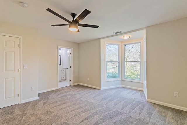 unfurnished room with ceiling fan and light colored carpet