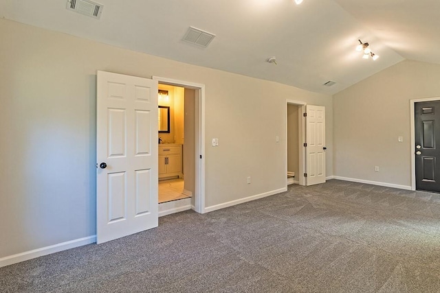 carpeted spare room featuring lofted ceiling