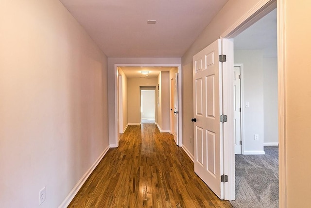 hall with dark wood-type flooring