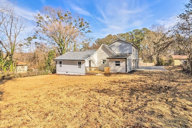 rear view of property featuring a lawn