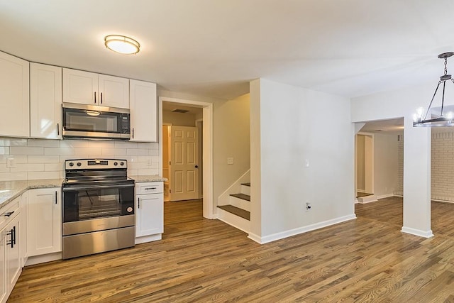 kitchen with appliances with stainless steel finishes, backsplash, and white cabinetry