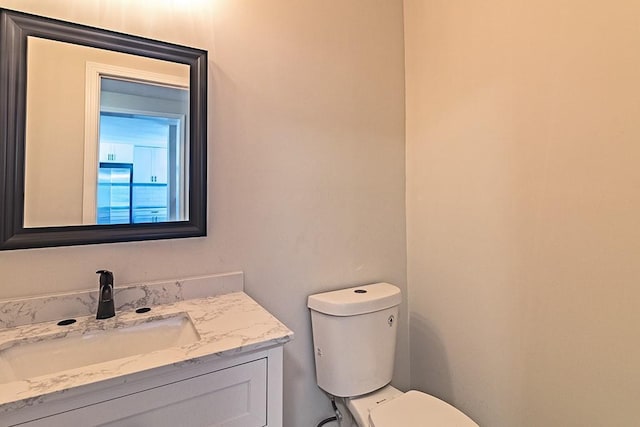 bathroom with toilet and vanity