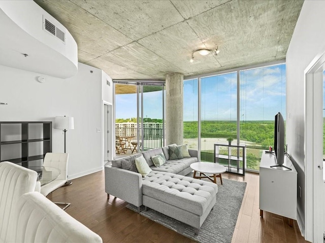living room with expansive windows, dark wood-style floors, and visible vents