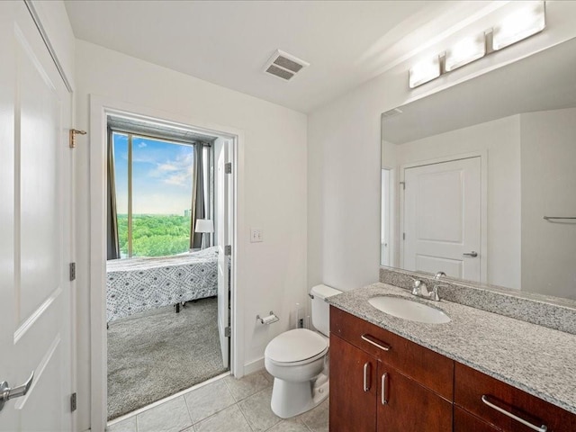 bathroom with toilet, visible vents, baseboards, tile patterned flooring, and vanity