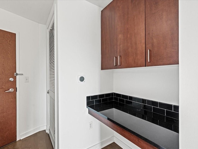 bathroom with wood finished floors, baseboards, and backsplash