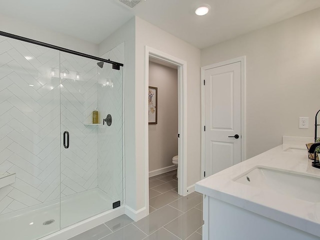 bathroom featuring vanity, an enclosed shower, tile patterned floors, and toilet