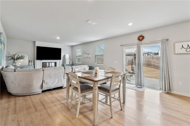 dining space featuring baseboards, light wood finished floors, visible vents, and recessed lighting