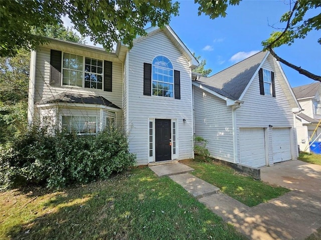 front of property featuring a front yard and a garage