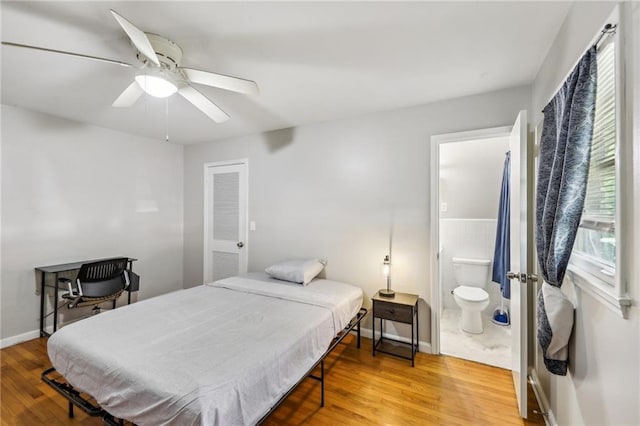 bedroom with ceiling fan, wood-type flooring, and connected bathroom