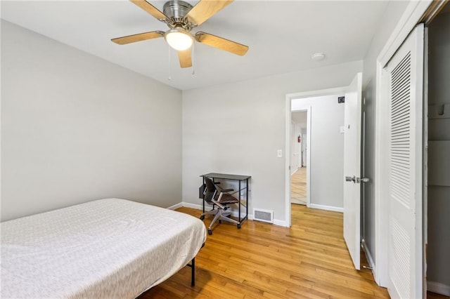 bedroom featuring a closet, ceiling fan, and light hardwood / wood-style flooring