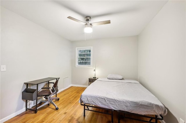 bedroom featuring hardwood / wood-style flooring and ceiling fan