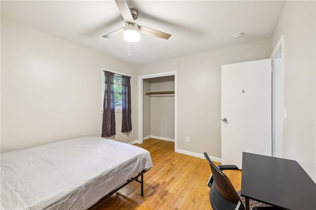 bedroom with hardwood / wood-style flooring, a closet, and ceiling fan