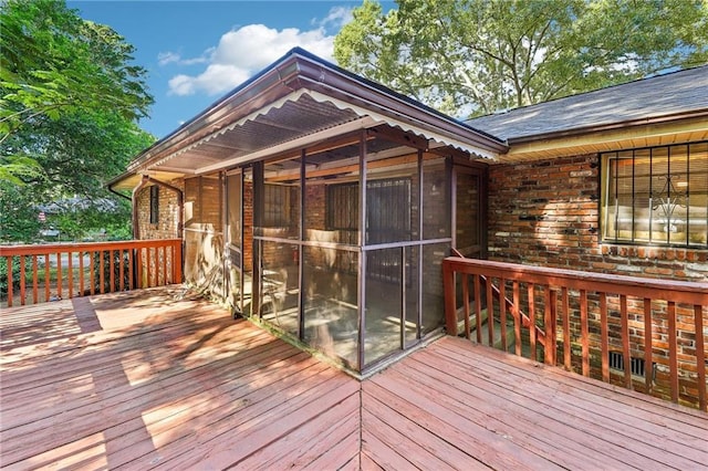 wooden deck featuring a sunroom