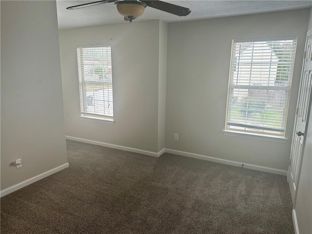 carpeted spare room featuring a textured ceiling and ceiling fan