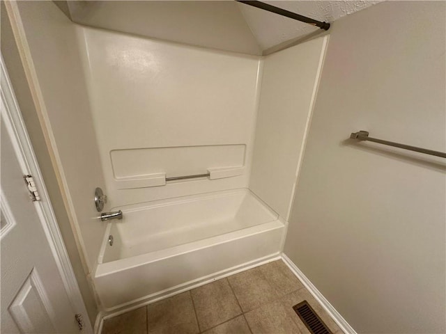 bathroom with tile patterned flooring and shower / bathtub combination