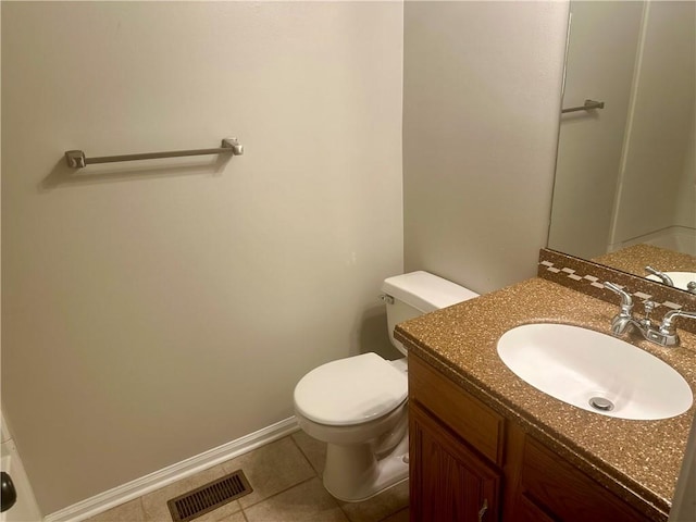 bathroom featuring toilet, vanity, and tile patterned floors